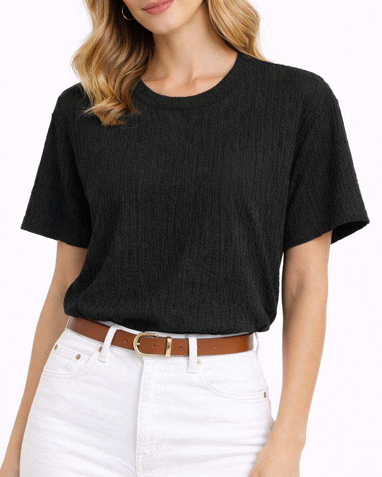 Woman wearing a black t-shirt and white pants on a white background