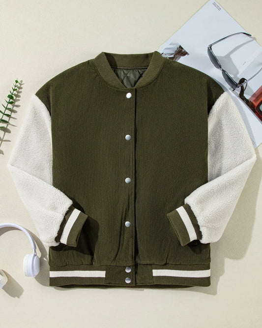 Green and white varsity jacket on a beige background
