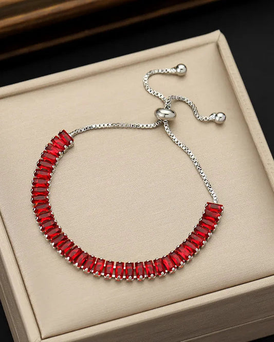 Red beaded bracelet on a beige jewelry box