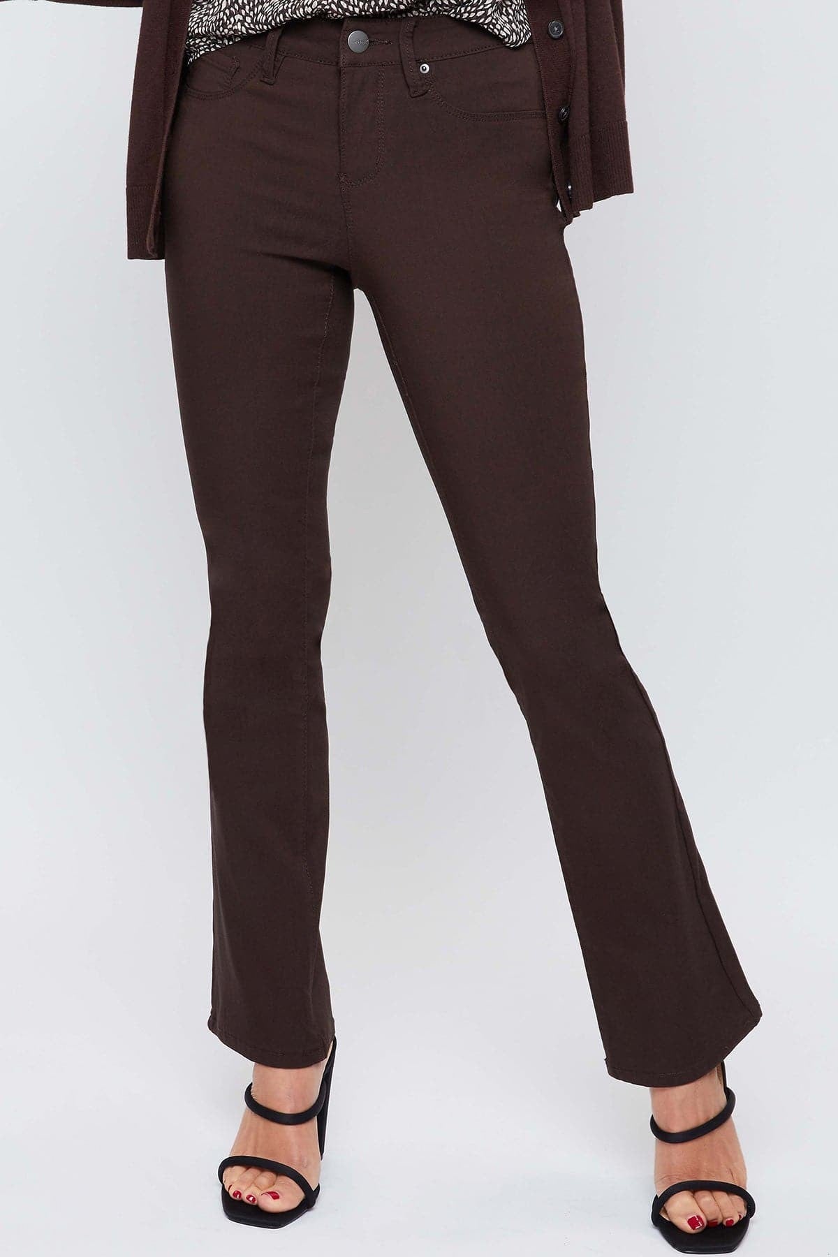 Brown pants worn by a person on a white background