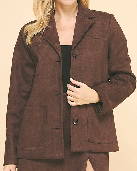 Woman wearing a brown suit on a beige background