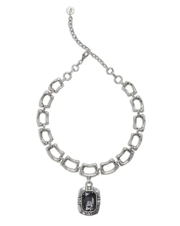 Silver chain necklace with a pendant on a white background