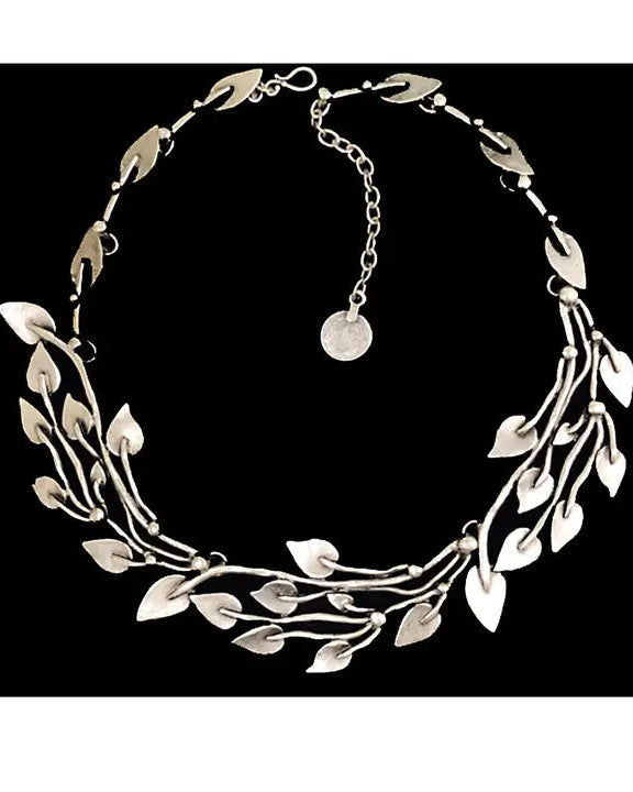 Silver leaf-shaped necklace on a black background