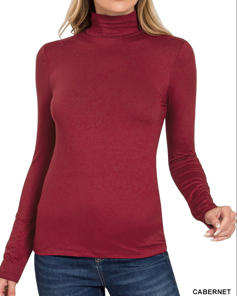 Woman wearing a cabernet turtleneck sweater on a white background