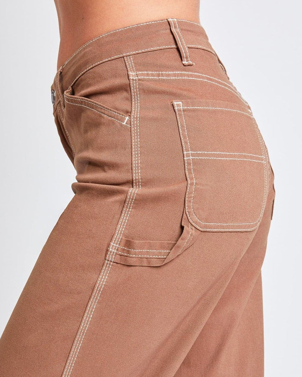 Brown pants with white stitching on a light gray background