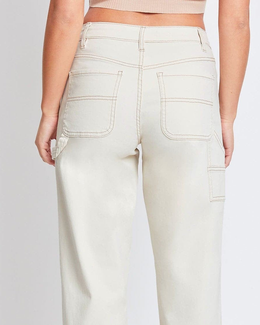 Light-colored jeans worn by a person on a white background