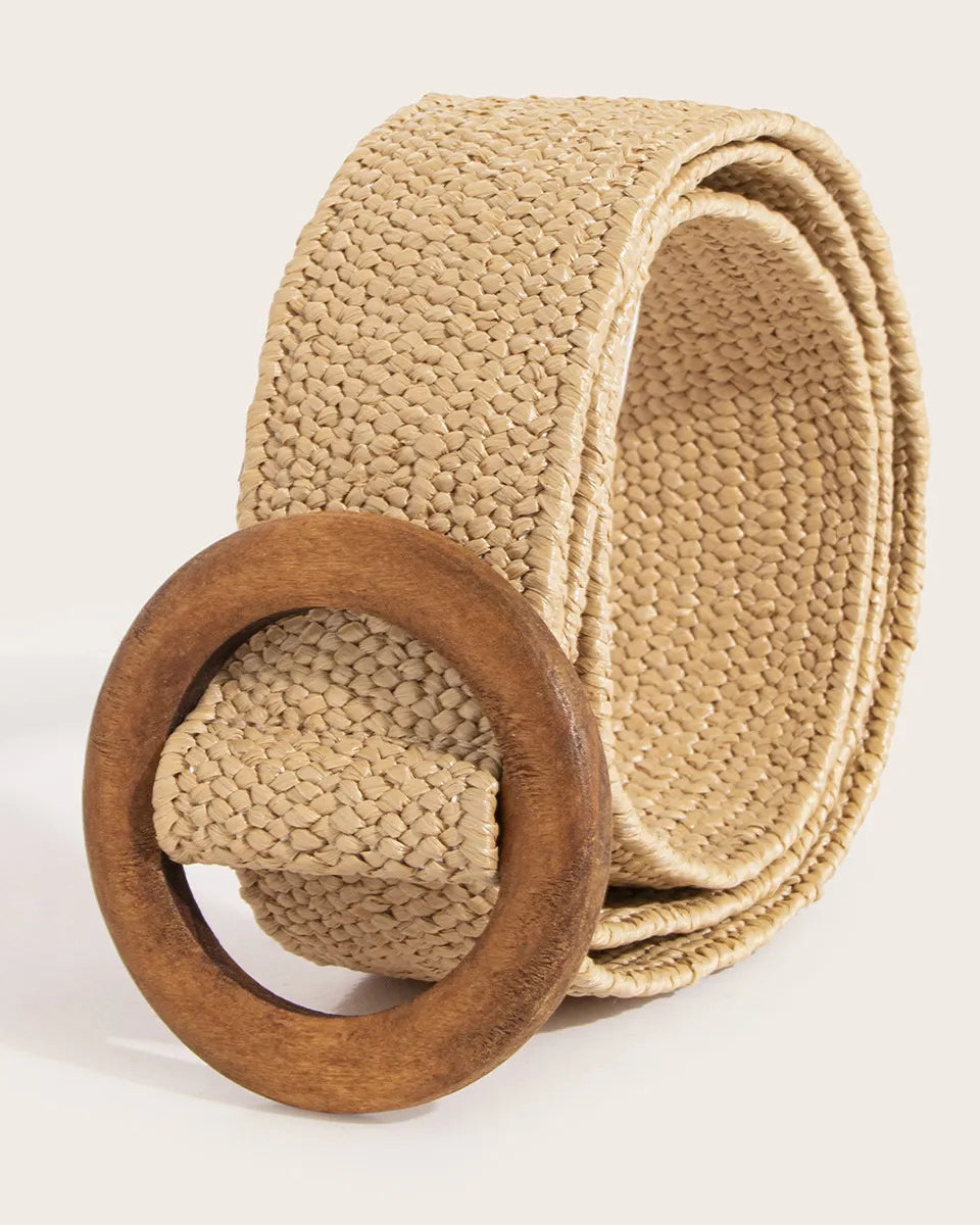 Beige belt with a wooden buckle on a light beige background