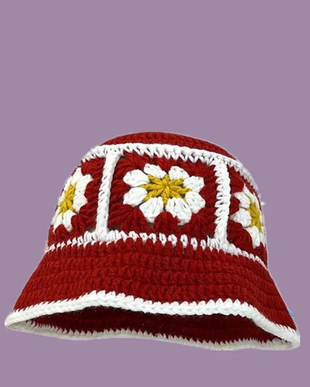 Crocheted sun hat with floral patterns on a purple background