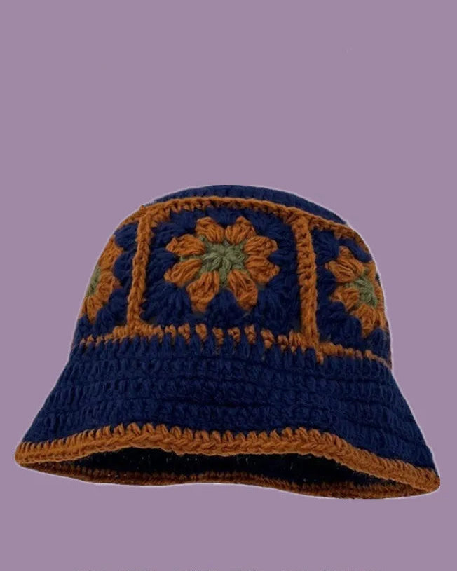 Hand-crocheted hat with floral patterns on a purple background