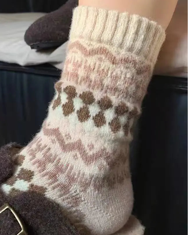 Close-up of a foot wearing a patterned sock with a dark brown shoe.