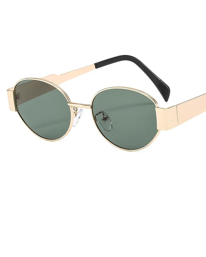 Sunglasses with gold frame and green lenses on a white background