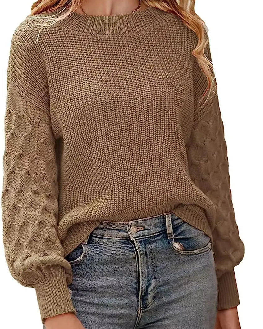 Woman wearing a brown knitted sweater and blue jeans on a white background