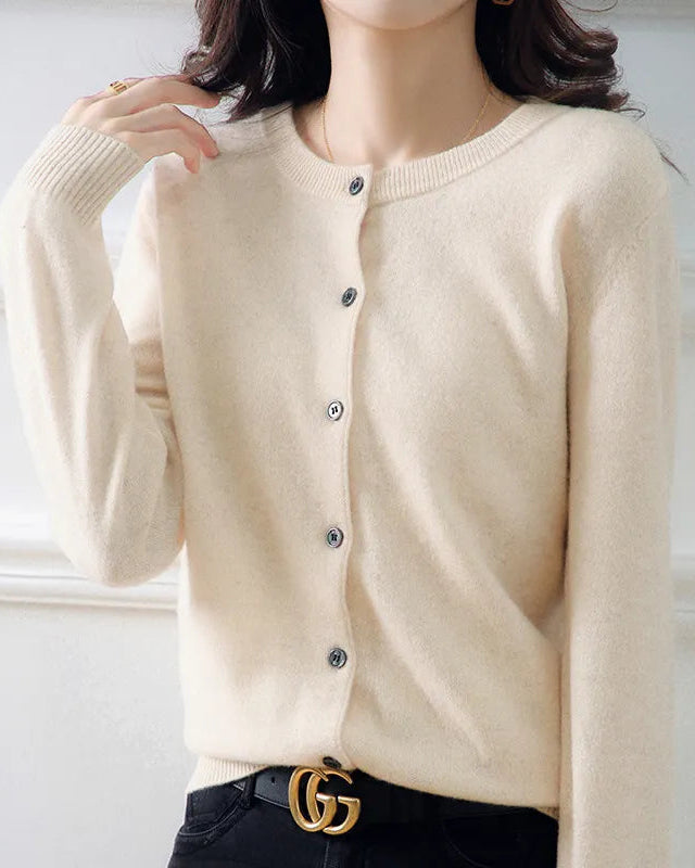 Beige cardigan worn by a person with a white background
