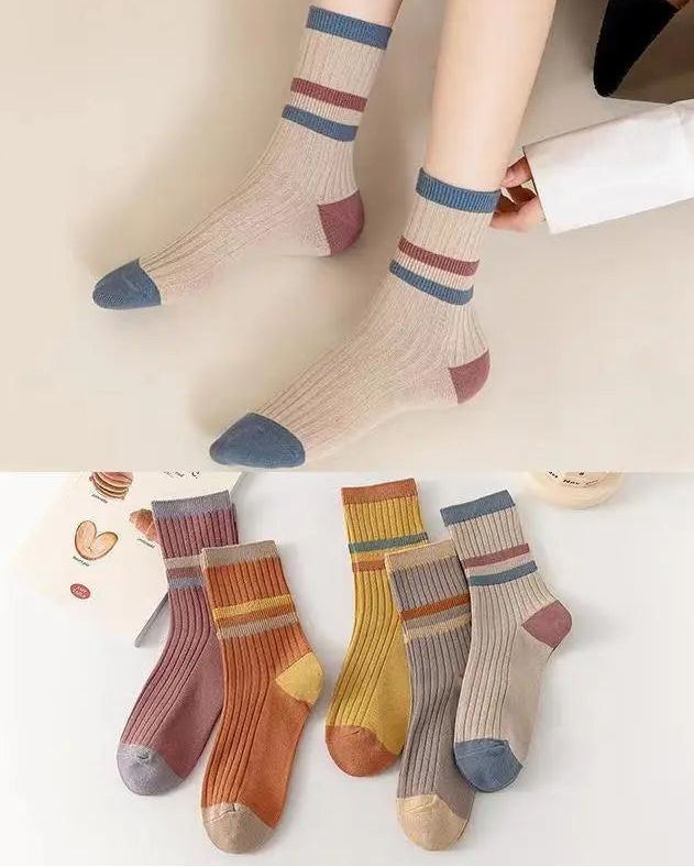 Colorful striped socks with a close-up of pairs on a white background.