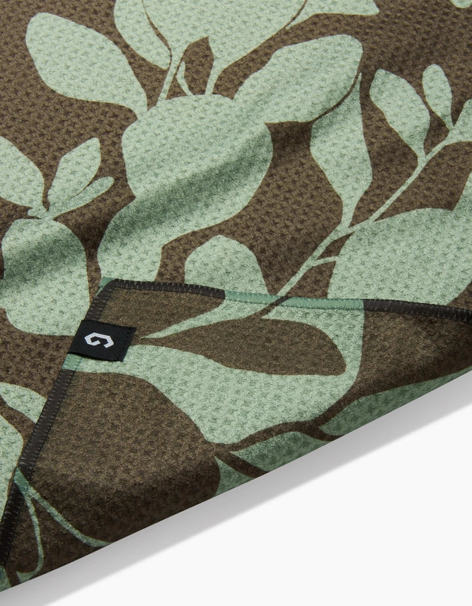 Floral patterned fabric with a brand label on a brown background