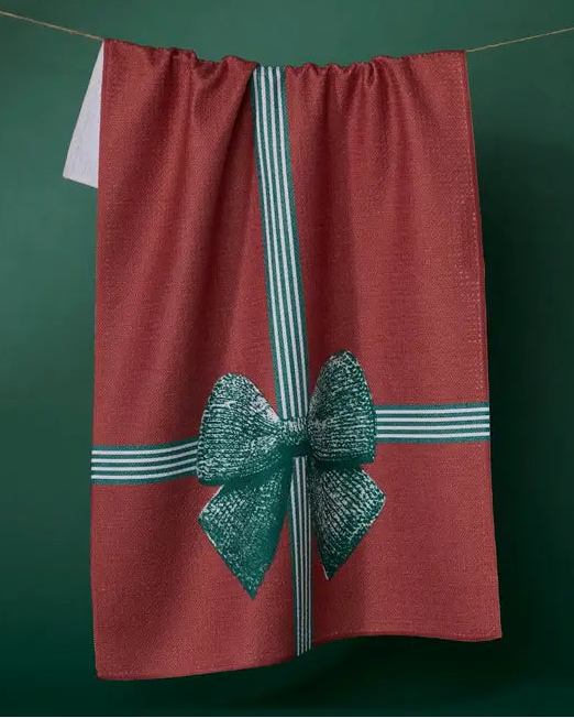 Red towel with a green bow and white stripes on a dark green background