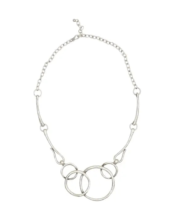 Silver necklace with interlocking rings on a white background