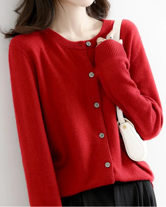 Person wearing a red cardigan against a white background