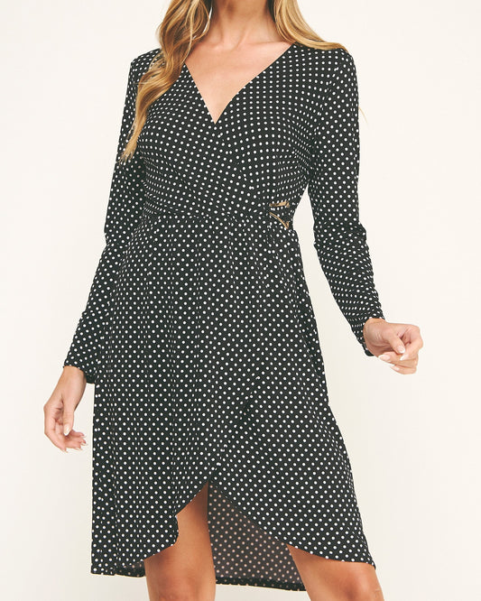 Woman wearing a black polka dot dress on a white background