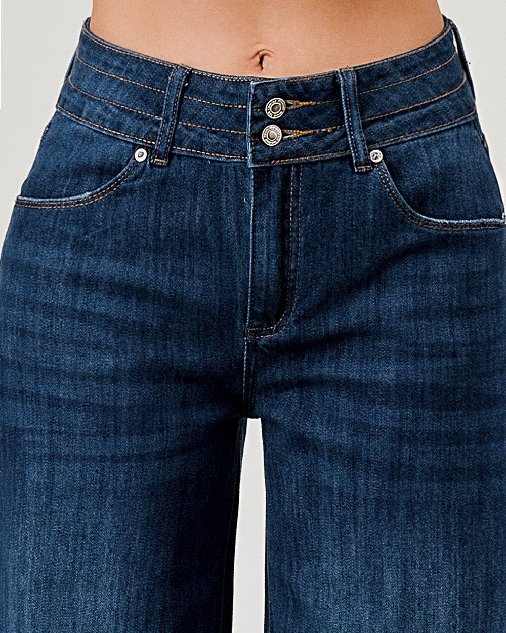 Close-up of blue jeans on a white background