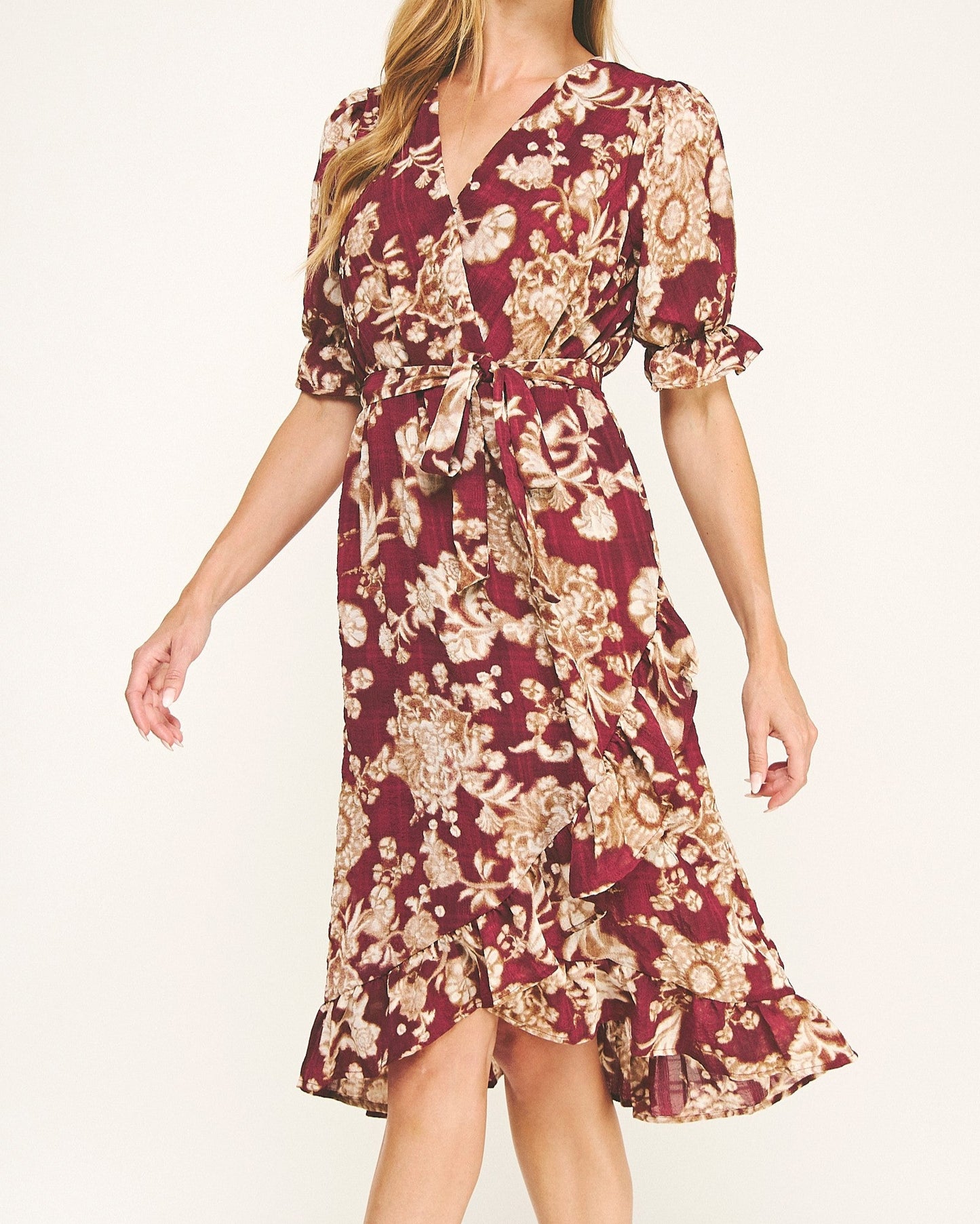 Woman wearing a floral dress with a white background