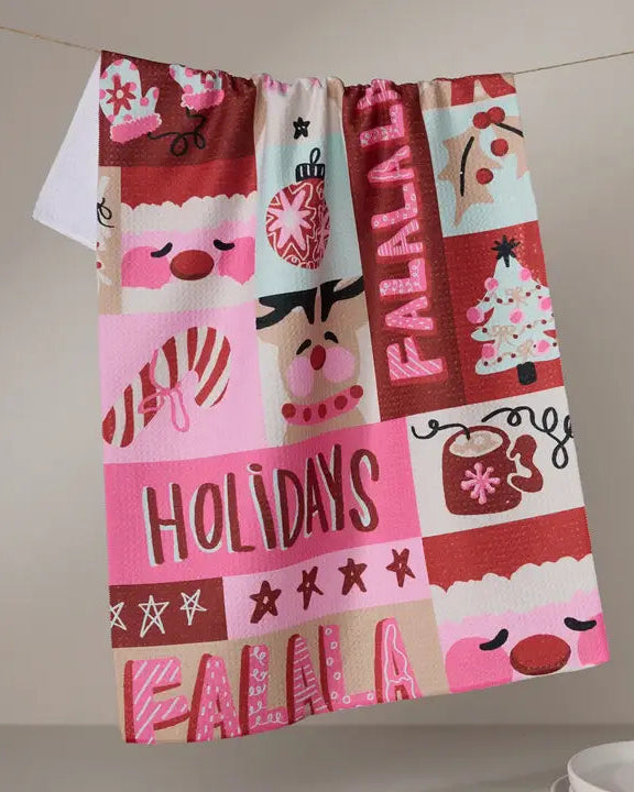 Decorative towel with festive patterns and text on a neutral background