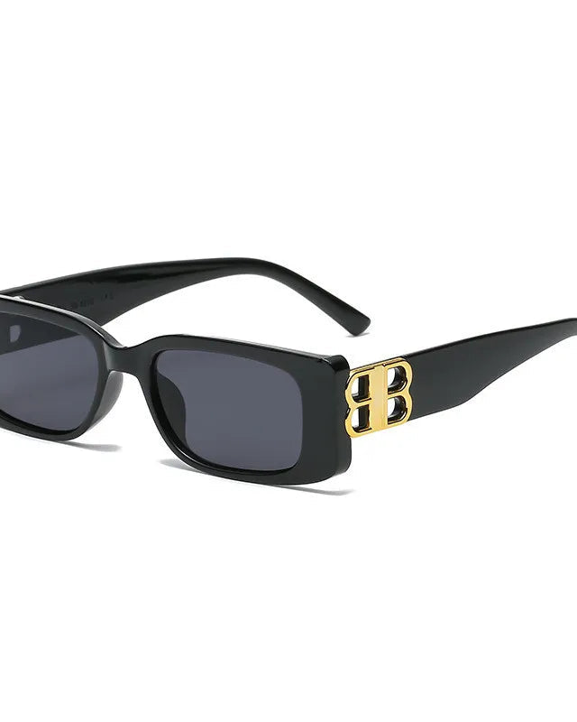 Black sunglasses with gold accents on a white background