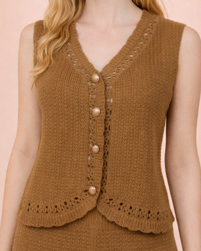 Woman wearing a brown knitted vest and shorts on a pink background
