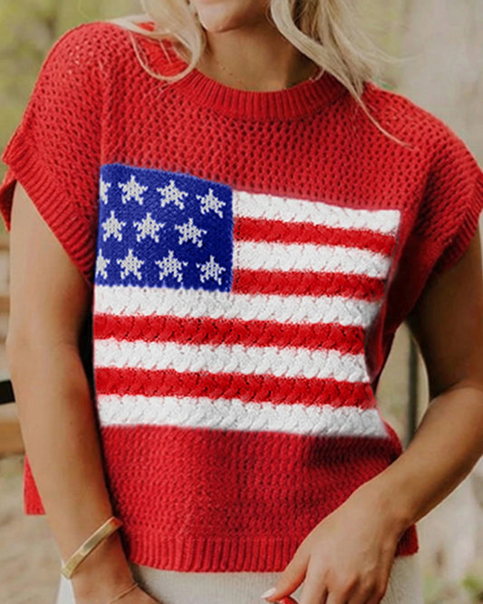Person wearing a red sweater with an American flag design, holding a Coca-Cola bottle.