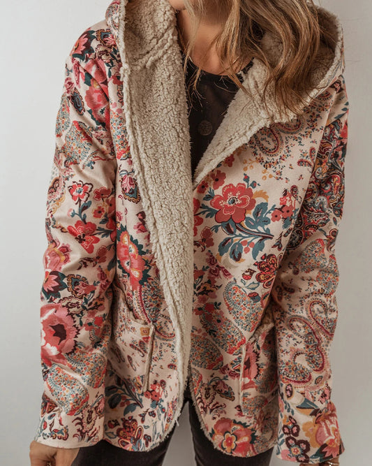 Floral patterned jacket with sherpa lining worn by a person on a plain background