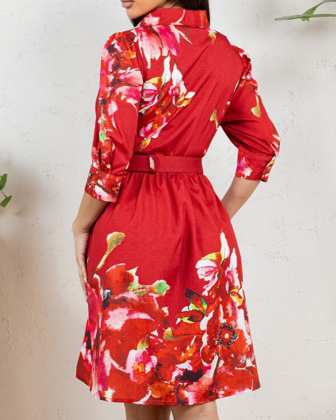 Red floral dress worn by a person on a white background