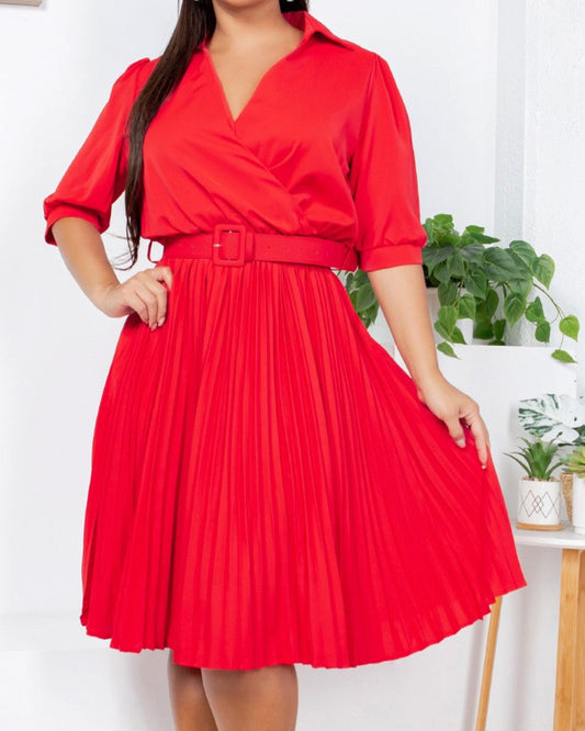 Woman wearing a red dress in a bright room with plants
