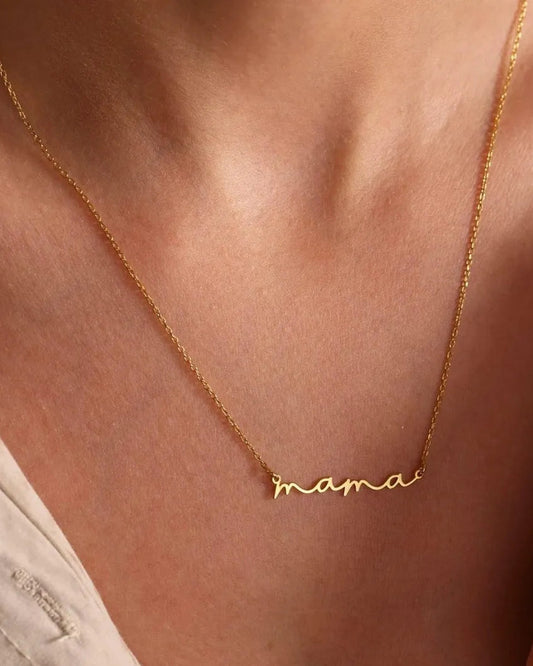 Gold 'mama' necklace on a person's neck