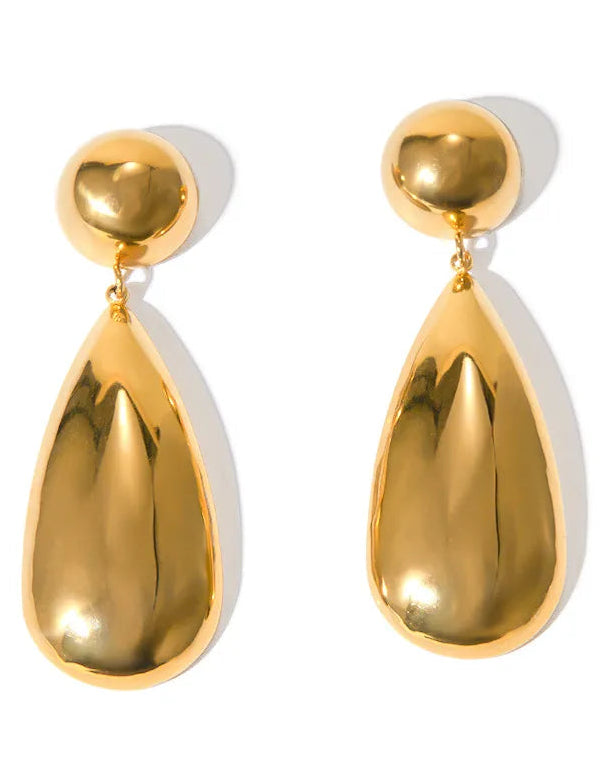 Gold teardrop earrings on a white background