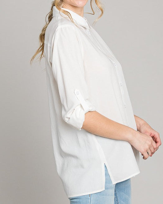 Woman wearing a white blouse and blue jeans on a gray background