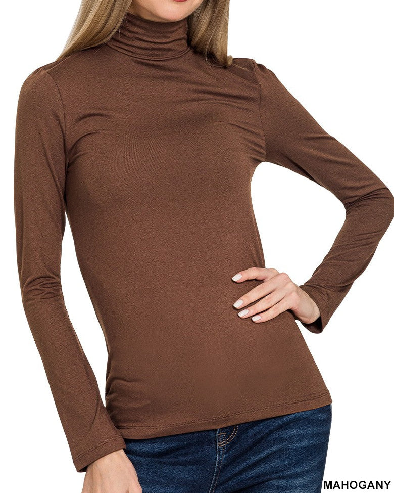 Woman wearing a brown turtleneck shirt on a white background