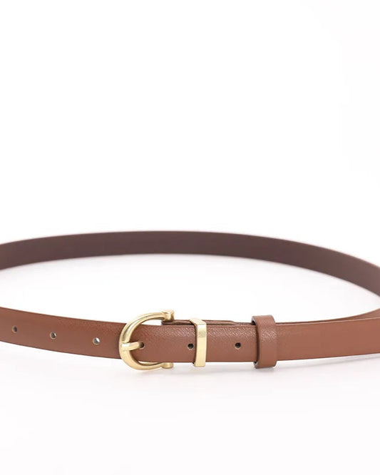 Close-up of gold square pin buckle and belt holes