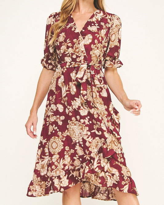 Woman wearing a burgundy floral dress on a white background