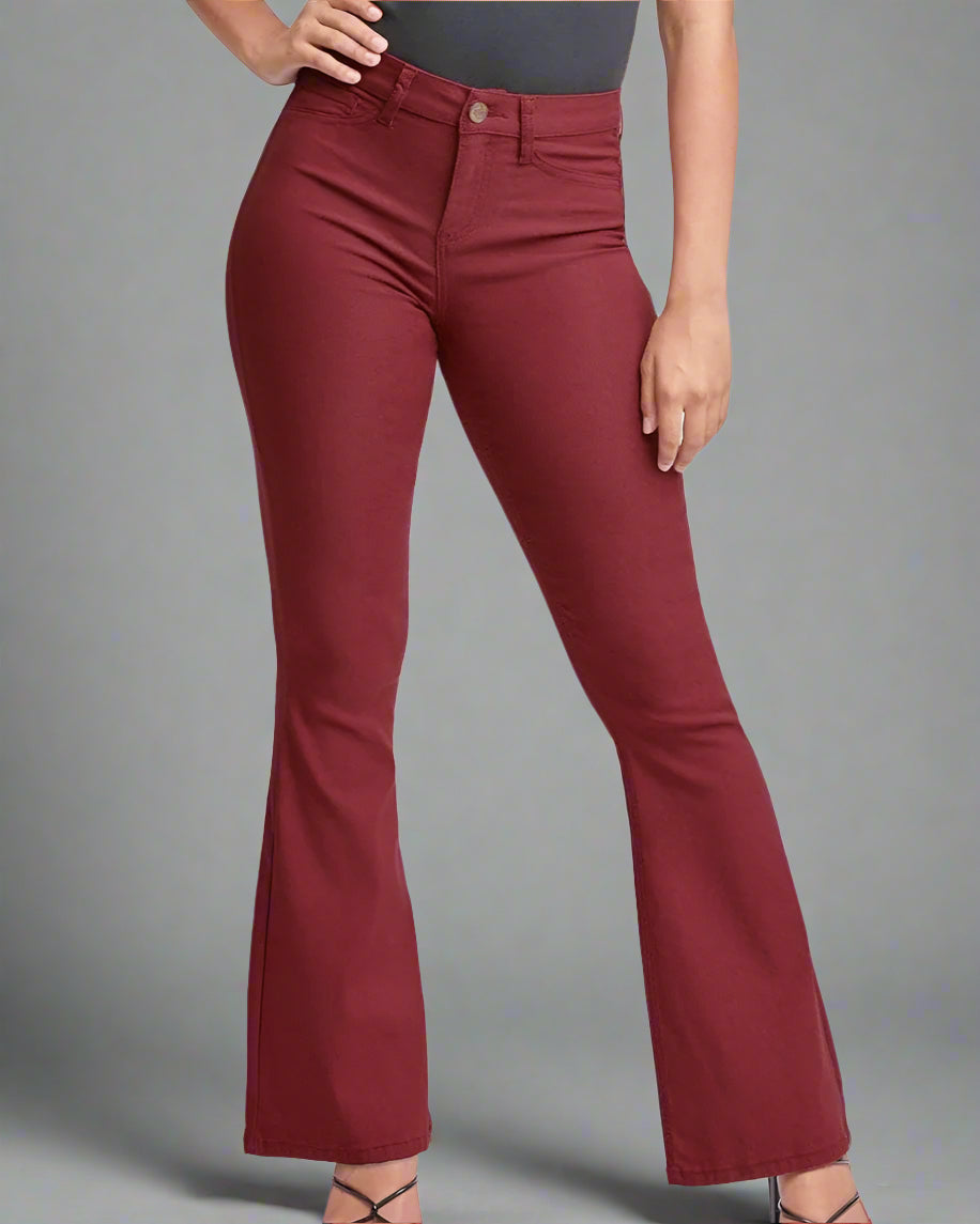 Maroon flared pants worn by a person on a white background