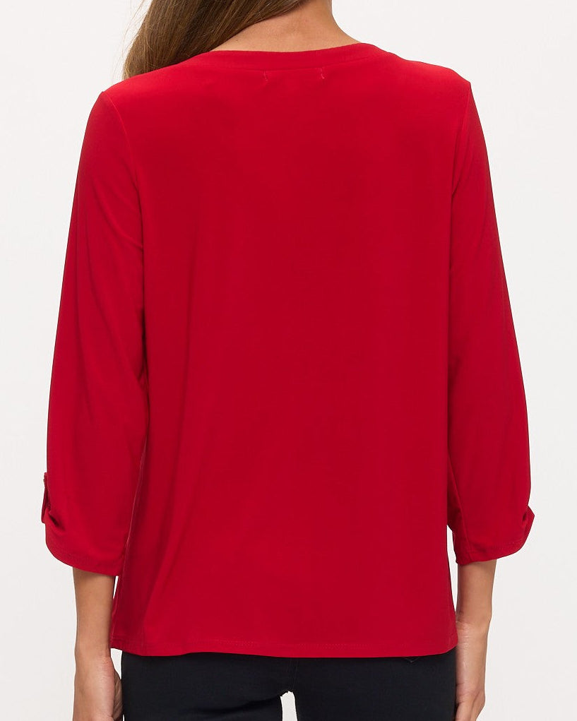 Red blouse worn by a person on a white background