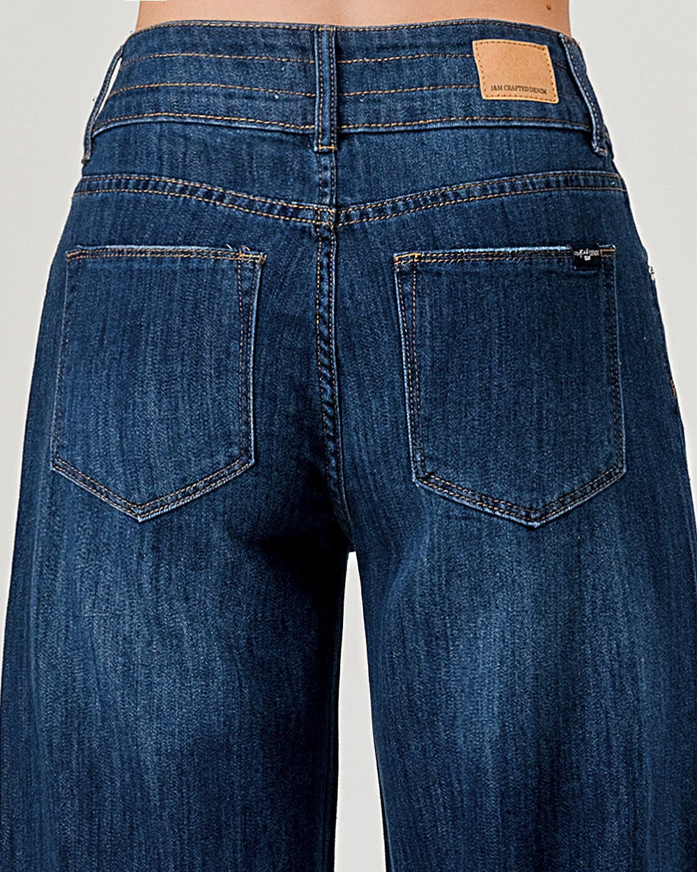 Blue jeans with a visible brand label on a white background