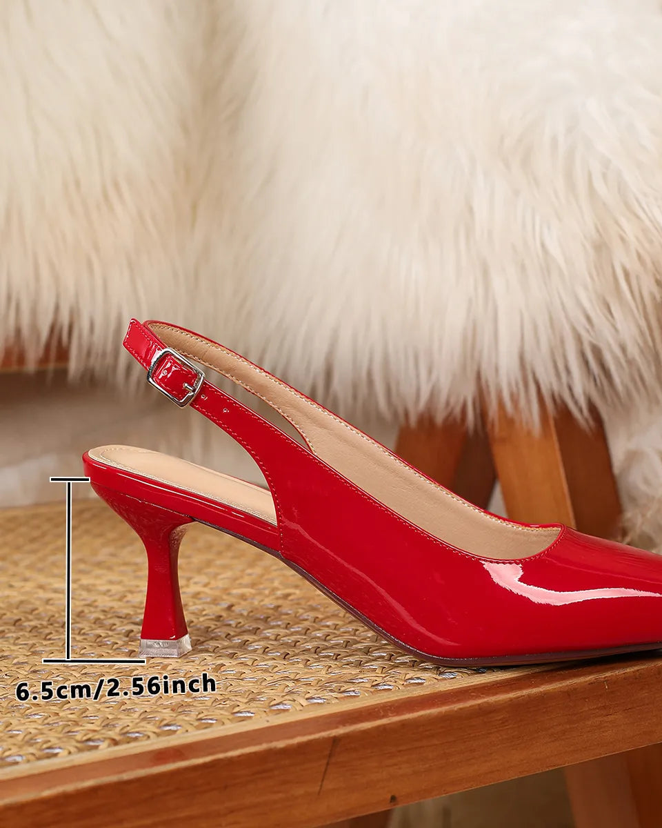 Red high-heeled shoe on a wooden surface with a fur background