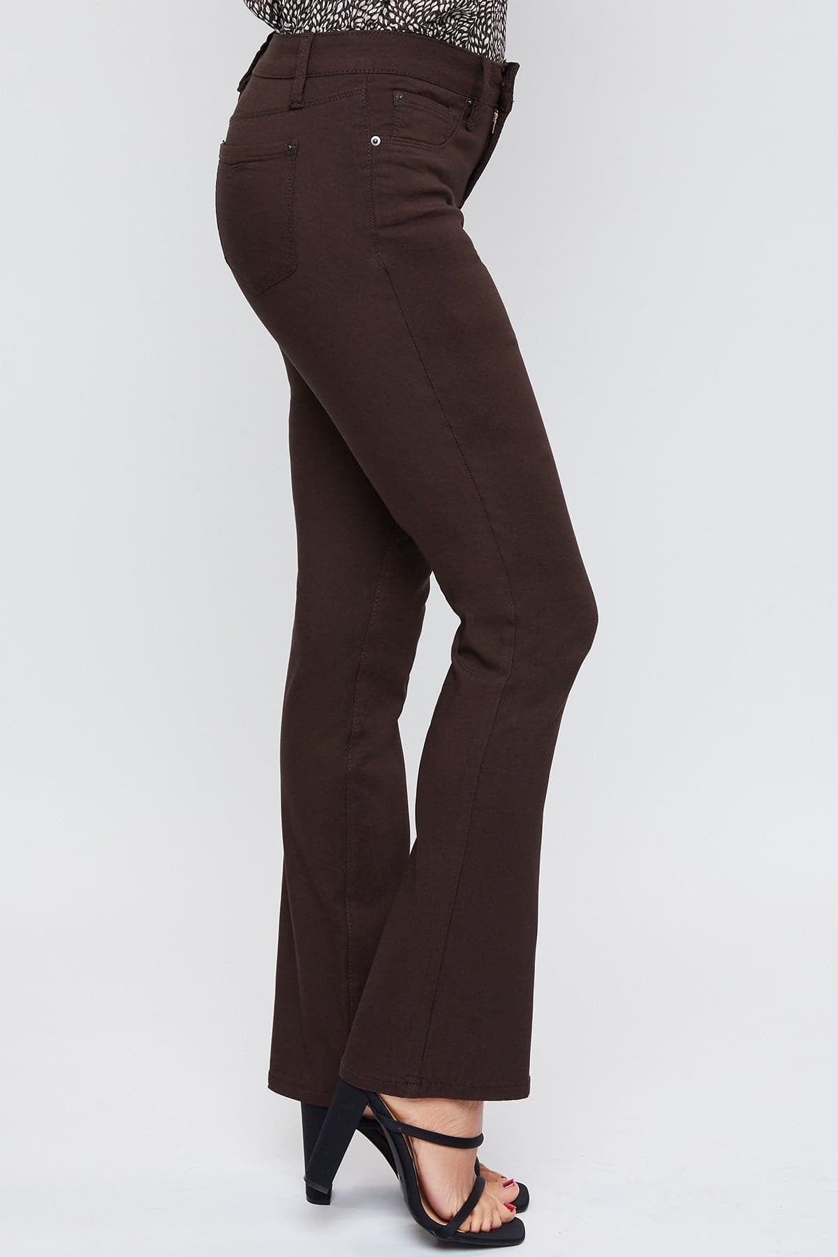 Brown pants worn by a person on a white background