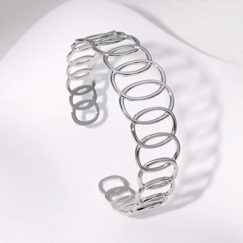 Silver spring-like bracelet on a white background