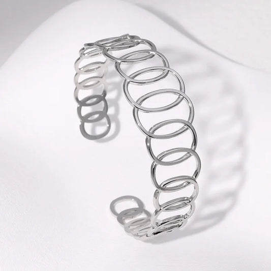 Silver spring-like bracelet on a white background
