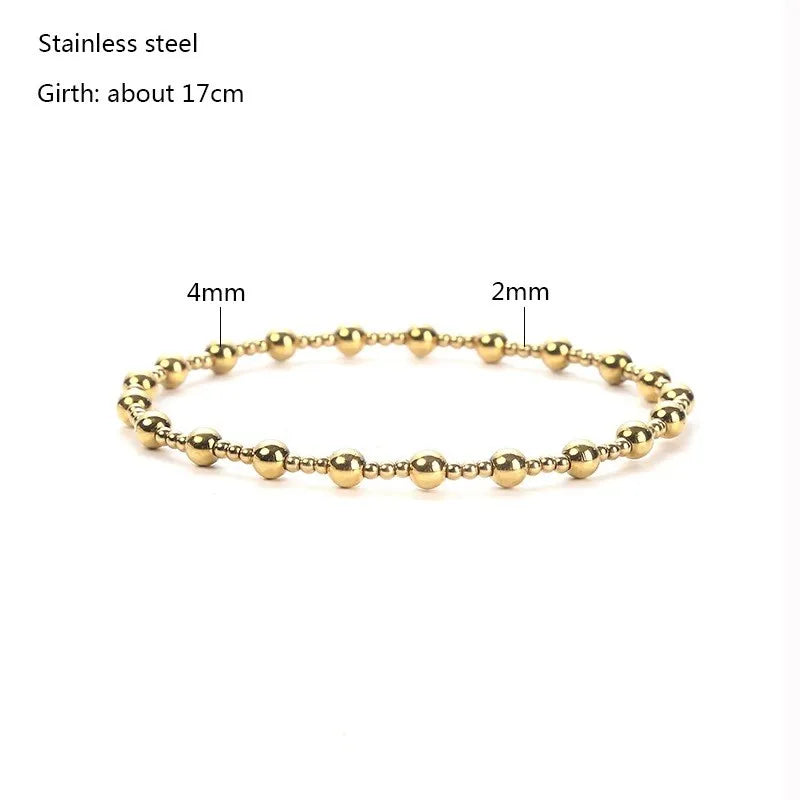 Gold bracelet with measurements on a white background