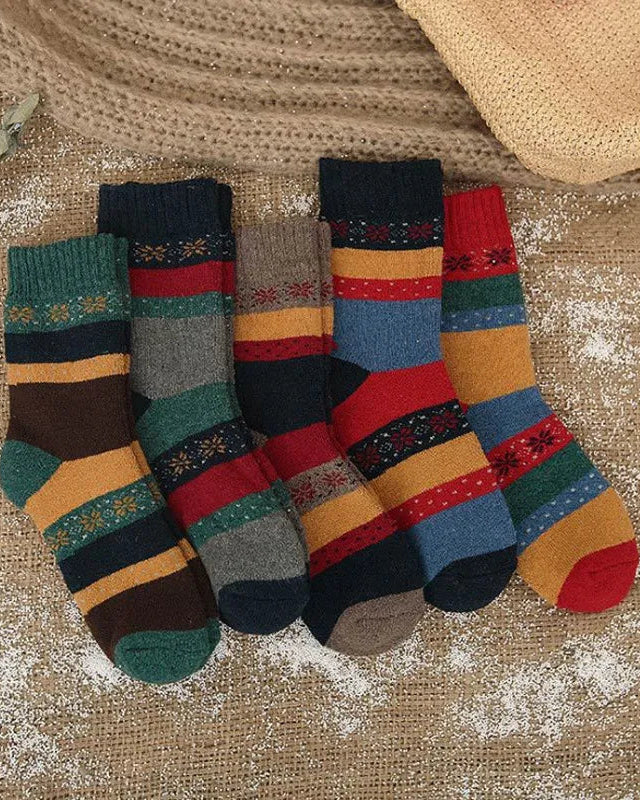 Colorful striped socks on a textured fabric background