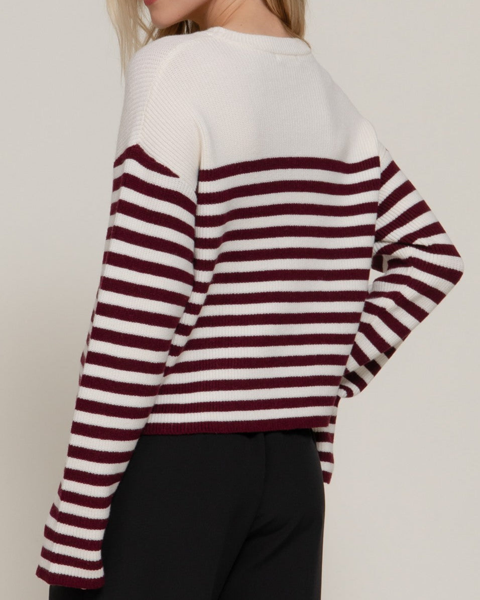 woman in  burgundy stripe sweater from side