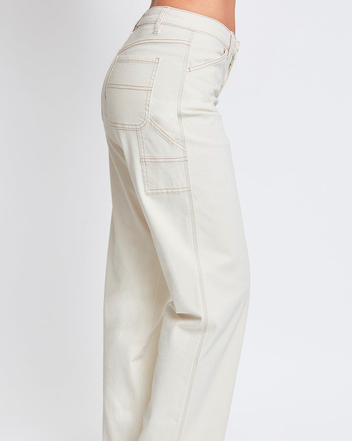 White pants worn by a person on a white background